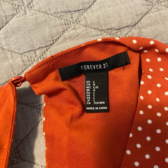 This is a mini burnt orange dress with white polka dots. Open back. - Picture 3 of 3